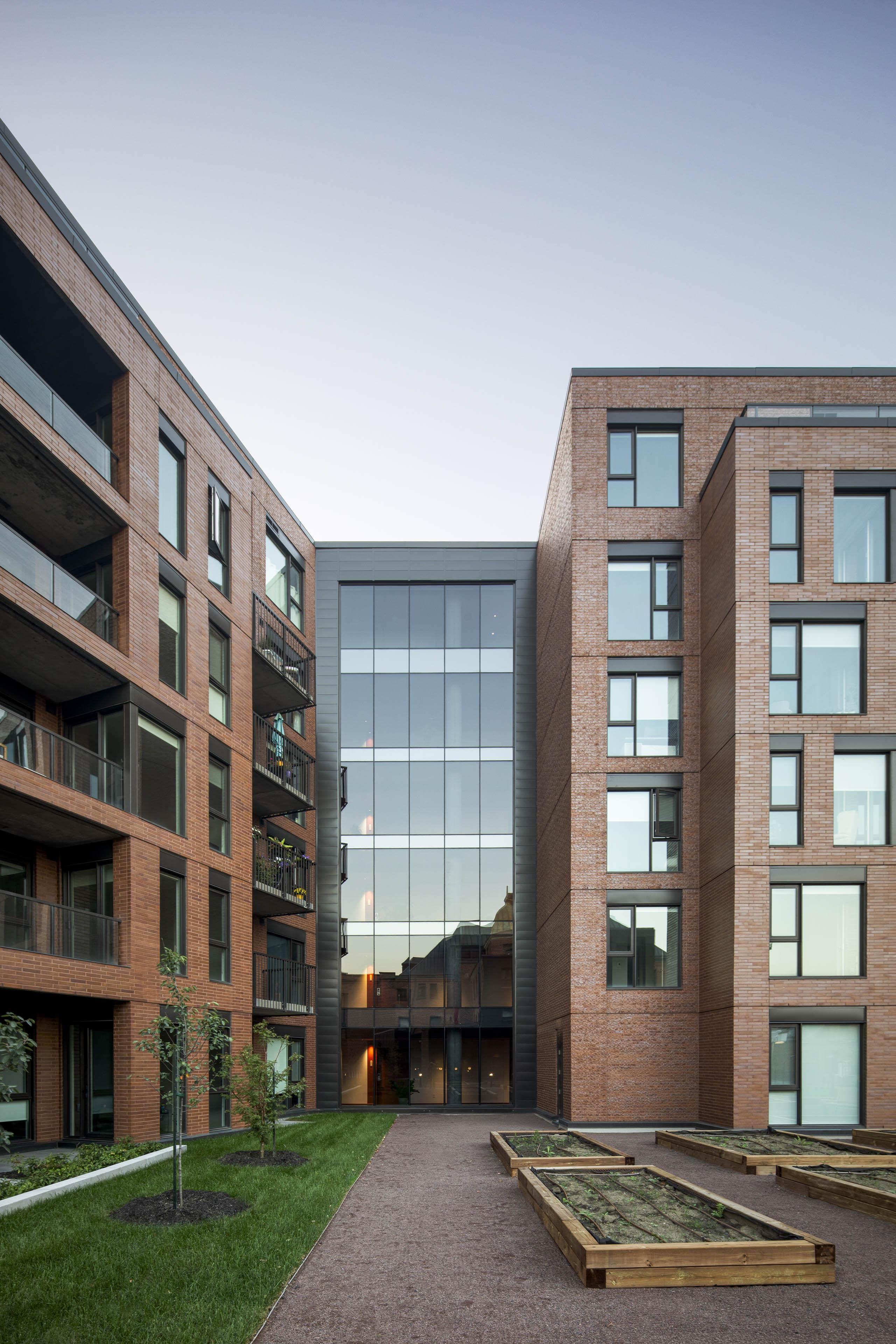 Shared outdoor spaces connect the new residential buildings. Landscape architecture is by KUB Paysage.