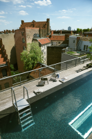Wilmina rooftop pool with wooden terrace overlooking the rooftops of Berlin.