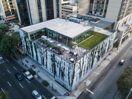 Aerial view of the Interface headquarters with rooftop terrace, green roof and surrounding city buildings.