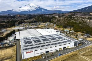 Okamura’s Gotemba facility with factory building, rooftop solar panels and Mount Fuji in the background.